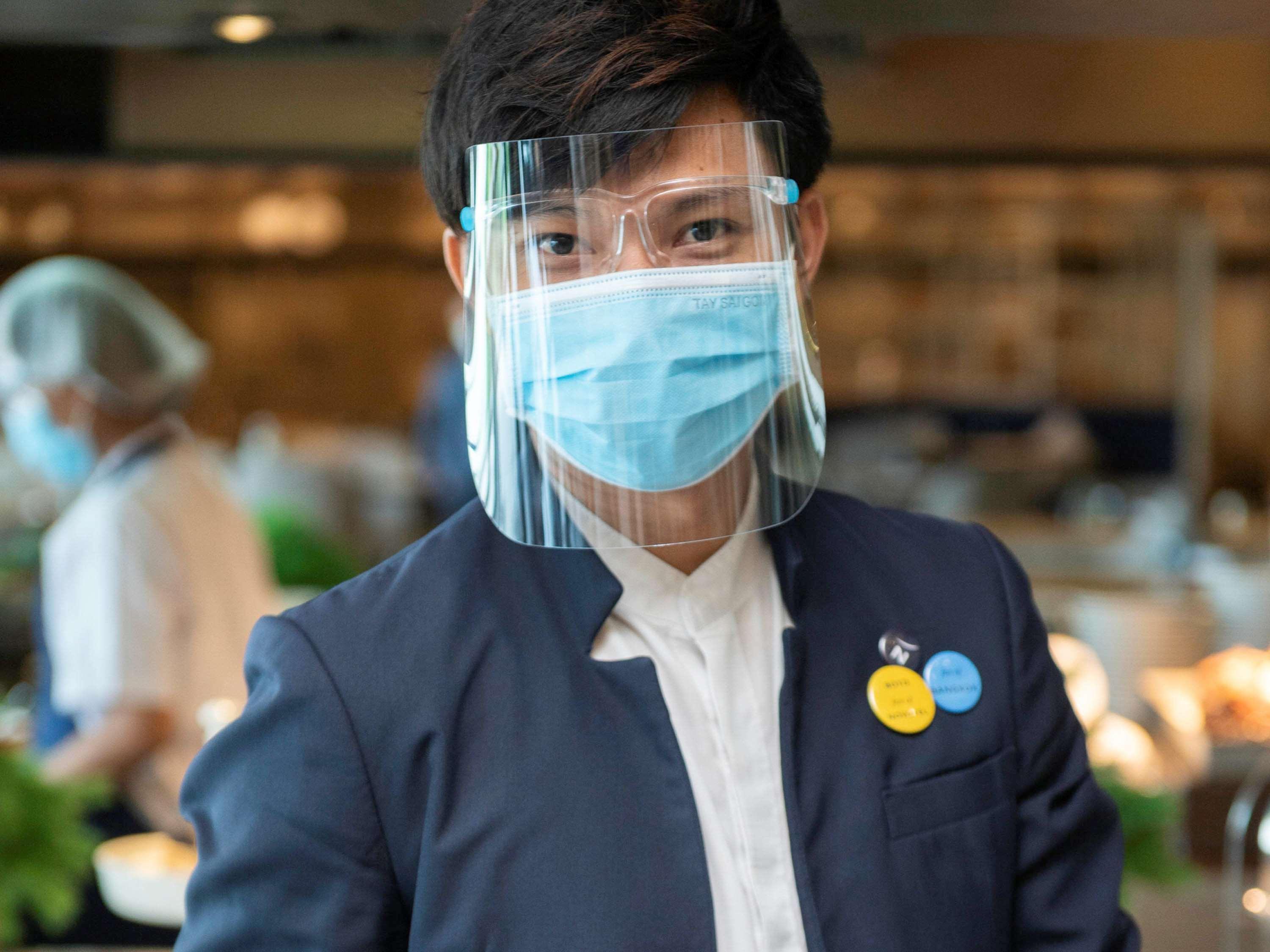Novotel Chennai Sipcot ภายนอก รูปภาพ A Thai Airways employee wearing a face shield
