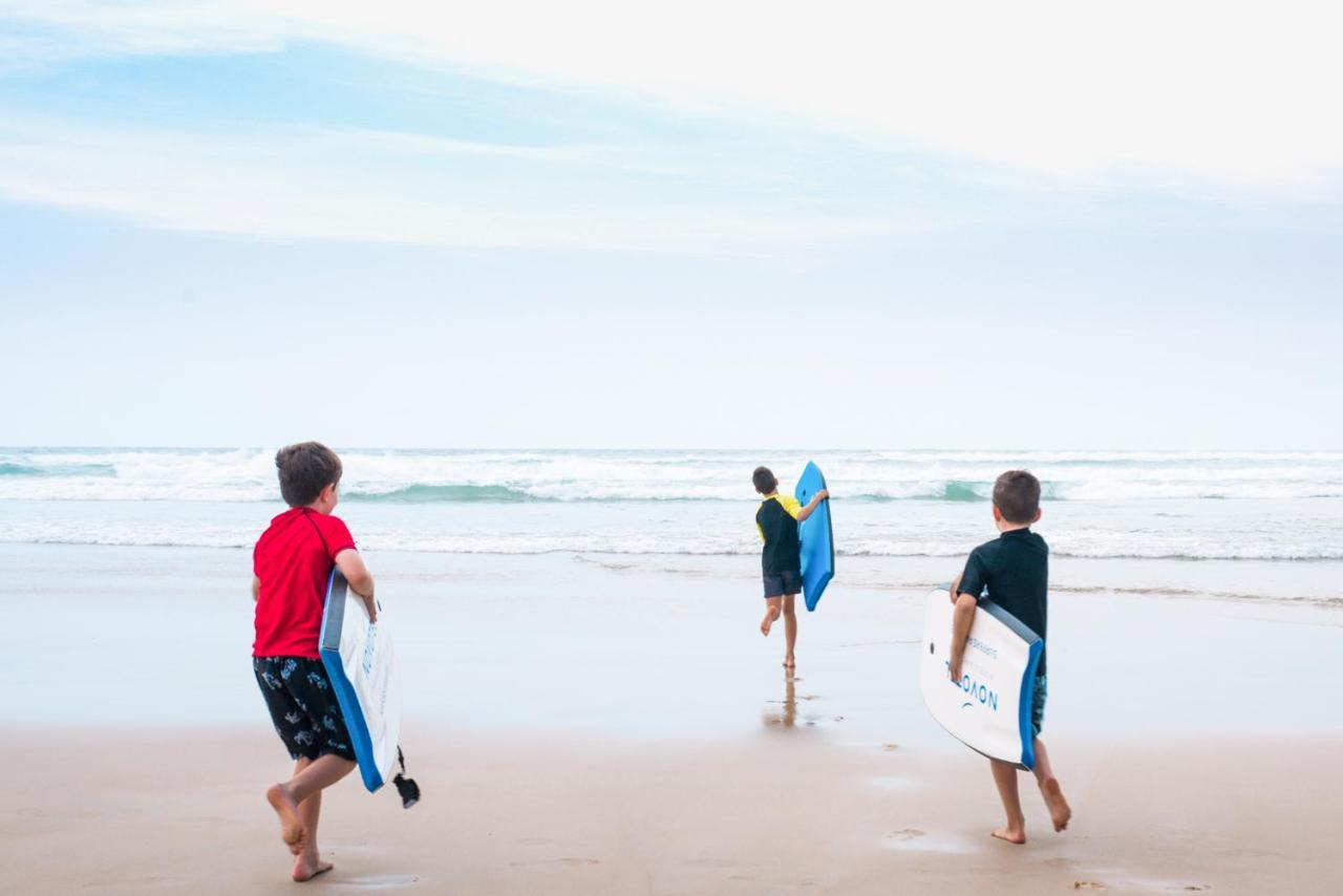Novotel Chennai Sipcot ภายนอก รูปภาพ Children learning to surf at the beach
